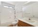 This bathroom has a bathtub with shower, toilet, sink and mirror at 1051 S 81St Way, Mesa, AZ 85208
