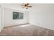 A bright bedroom with neutral carpet and a large window at 1051 S 81St Way, Mesa, AZ 85208
