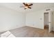 Bright bedroom with neutral carpet, ceiling fan, and open door at 1051 S 81St Way, Mesa, AZ 85208
