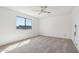 Bright bedroom featuring neutral carpet, ceiling fan, and ample natural light at 1051 S 81St Way, Mesa, AZ 85208