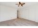 Bedroom with neutral carpet, ceiling fan, and closet at 1051 S 81St Way, Mesa, AZ 85208