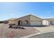 Charming single-story home with two-car garage, arched entryway, and desert landscaping at 1051 S 81St Way, Mesa, AZ 85208