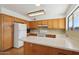 Bright kitchen features white appliances, light wood cabinetry, and ample counter space at 1051 S 81St Way, Mesa, AZ 85208