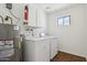 This laundry room has a washer, dryer, water heater, and cabinets at 1051 S 81St Way, Mesa, AZ 85208