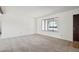 Bright living room featuring neutral carpet, white walls and a large window at 1051 S 81St Way, Mesa, AZ 85208