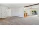 Spacious living area with a view into the dining room, kitchen, and covered patio at 1051 S 81St Way, Mesa, AZ 85208