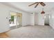 Spacious, light-filled living area featuring a sliding glass door to the covered patio at 1051 S 81St Way, Mesa, AZ 85208