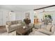 Bright living room with stylish furniture, decor, and an open view into the dining room and kitchen at 1051 S 81St Way, Mesa, AZ 85208