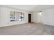 Bright living room with neutral carpet, white walls, and a charming arched window at 1051 S 81St Way, Mesa, AZ 85208