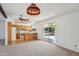 Open living space features a stained glass light, ceiling fan, and a sliding glass door to the patio at 1051 S 81St Way, Mesa, AZ 85208