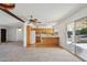 Open living space features a stained glass light, ceiling fan, and a sliding glass door to the patio at 1051 S 81St Way, Mesa, AZ 85208