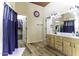 Bathroom with wood flooring, double sinks, walk in closet, and a separate doorway at 1123 E Shepherds Way, Casa Grande, AZ 85122