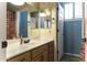 Bathroom with modern faucet, white countertop, and wood cabinets at 1123 E Shepherds Way, Casa Grande, AZ 85122