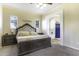 Inviting bedroom with archway to bathroom, carpet flooring, and natural light at 1123 E Shepherds Way, Casa Grande, AZ 85122