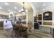 Charming dining area connected to kitchen features a wooden table and chandelier lighting at 1123 E Shepherds Way, Casa Grande, AZ 85122