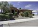 Beautiful single-story home with desert landscaping, mature trees, and a welcoming front entrance at 1123 E Shepherds Way, Casa Grande, AZ 85122