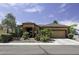 Charming single-story home featuring desert landscaping, a tile roof, and attached garage at 1123 E Shepherds Way, Casa Grande, AZ 85122
