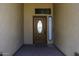 Elegant front entry featuring a decorative glass door, sidelight, and stylish welcome mat at 1123 E Shepherds Way, Casa Grande, AZ 85122