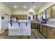 Spacious kitchen with stainless steel appliances, island with breakfast bar, and ample cabinet space at 1123 E Shepherds Way, Casa Grande, AZ 85122