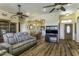 Open-concept living room and dining area with hardwood floors, ceiling fans, and ample seating at 1123 E Shepherds Way, Casa Grande, AZ 85122