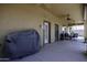 Covered patio with ceiling fans, seating area, and barbecue; great for outdoor entertaining at 1123 E Shepherds Way, Casa Grande, AZ 85122