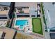 Stunning aerial view of a backyard with a pool, spa, putting green, and outdoor lounge area at 1221 E Paseo Way, Phoenix, AZ 85042