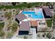 Aerial view of pool and clubhouse featuring a lap pool, lounge seating, and outdoor grilling area at 1221 E Paseo Way, Phoenix, AZ 85042