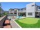 Beautiful backyard with a putting green, pool, spa, outdoor kitchen, and patio for upscale living and entertaining at 1221 E Paseo Way, Phoenix, AZ 85042