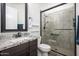 Well-lit bathroom showcasing a granite-topped vanity and a modern glass-enclosed shower at 1221 E Paseo Way, Phoenix, AZ 85042