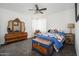 Bright bedroom with ceiling fan, neutral walls, and a beautiful dresser and carved wooden chest at 1221 E Paseo Way, Phoenix, AZ 85042