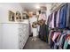 Walk-in closet with custom shelving and ample storage for clothing, shoes and accessories at 1221 E Paseo Way, Phoenix, AZ 85042
