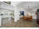Open-concept dining room flows into the living area with beautiful wood-look tile floors at 1221 E Paseo Way, Phoenix, AZ 85042