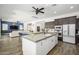 Spacious kitchen with a large island, modern appliances, and an open floor plan to the living room at 1221 E Paseo Way, Phoenix, AZ 85042
