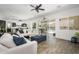 Bright, open-concept living room with comfortable seating and a view of the backyard pool at 1221 E Paseo Way, Phoenix, AZ 85042