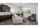 Comfortable living room featuring a neutral-toned sofa, a pendant light, and ample natural light at 1221 E Paseo Way, Phoenix, AZ 85042