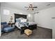 Elegant main bedroom features a dark wood bed frame, plush carpet, and a stylish ceiling fan with light fixture at 1221 E Paseo Way, Phoenix, AZ 85042
