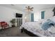 Spacious main bedroom with a ceiling fan, a flat screen television, an accent chair, and bright window views at 1221 E Paseo Way, Phoenix, AZ 85042