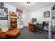 Functional office space with ample display shelving, a comfortable chair, and bright lighting at 1221 E Paseo Way, Phoenix, AZ 85042