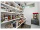 Organized pantry with shelving stocked with goods and supplies, complete with a vintage popcorn maker at 1221 E Paseo Way, Phoenix, AZ 85042