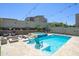 Backyard with a refreshing pool, spa, built-in fire pit and string lights, ideal for entertaining at 1221 E Paseo Way, Phoenix, AZ 85042