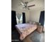 Bedroom with a decorative ceiling fan and floral bedding at 1222 E Almeria Rd, Phoenix, AZ 85006