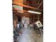 Cluttered garage interior featuring storage, bikes, tools and a roll-up door at 1222 E Almeria Rd, Phoenix, AZ 85006