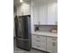 Stainless steel refrigerator complementing white cabinets and countertops in the modern kitchen at 1222 E Almeria Rd, Phoenix, AZ 85006