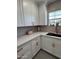 Modern kitchen featuring white cabinets, copper hardware, and sleek countertops at 1222 E Almeria Rd, Phoenix, AZ 85006