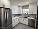 Modern kitchen featuring stainless steel appliances, white cabinetry, and a stylish backsplash at 1222 E Almeria Rd, Phoenix, AZ 85006