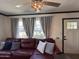 Comfortable living room featuring plush seating, natural light, and a decorative ceiling fan at 1222 E Almeria Rd, Phoenix, AZ 85006