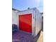 Exterior view of the storage shed with red door, surrounded by desert landscaping at 1222 E Almeria Rd, Phoenix, AZ 85006