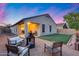 Relaxing backyard area, complete with comfortable seating around a fire pit and green grass at 13657 W Paso Trl, Peoria, AZ 85383
