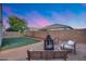 This backyard features a fire pit, patio furniture, and a nice grassy area at 13657 W Paso Trl, Peoria, AZ 85383