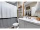 This cozy bathroom has a shower with a curtain, a mirror above the sink, and some decor at 13657 W Paso Trl, Peoria, AZ 85383